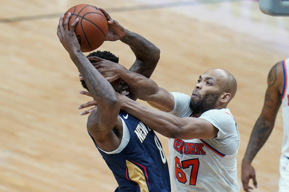 New York Knicks center Taj Gibson (67) fouls New Orleans Pelicans forward Naji Marshall (8) as he drives to the basket in the second half of an NBA basketball game in New Orleans, Wednesday, April 14, 2021. (AP Photo/Gerald Herbert)