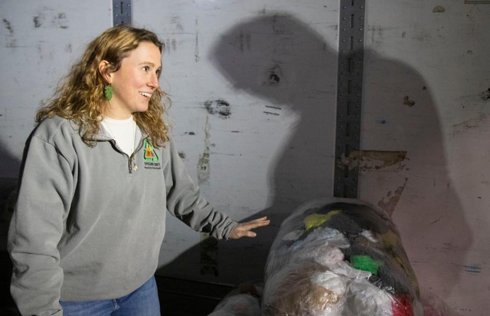 Madison Neher loads up plastic bags into a trailer, Thursday, Feb. 1, 2024, at Meijer’s in Lafayette, Ind.