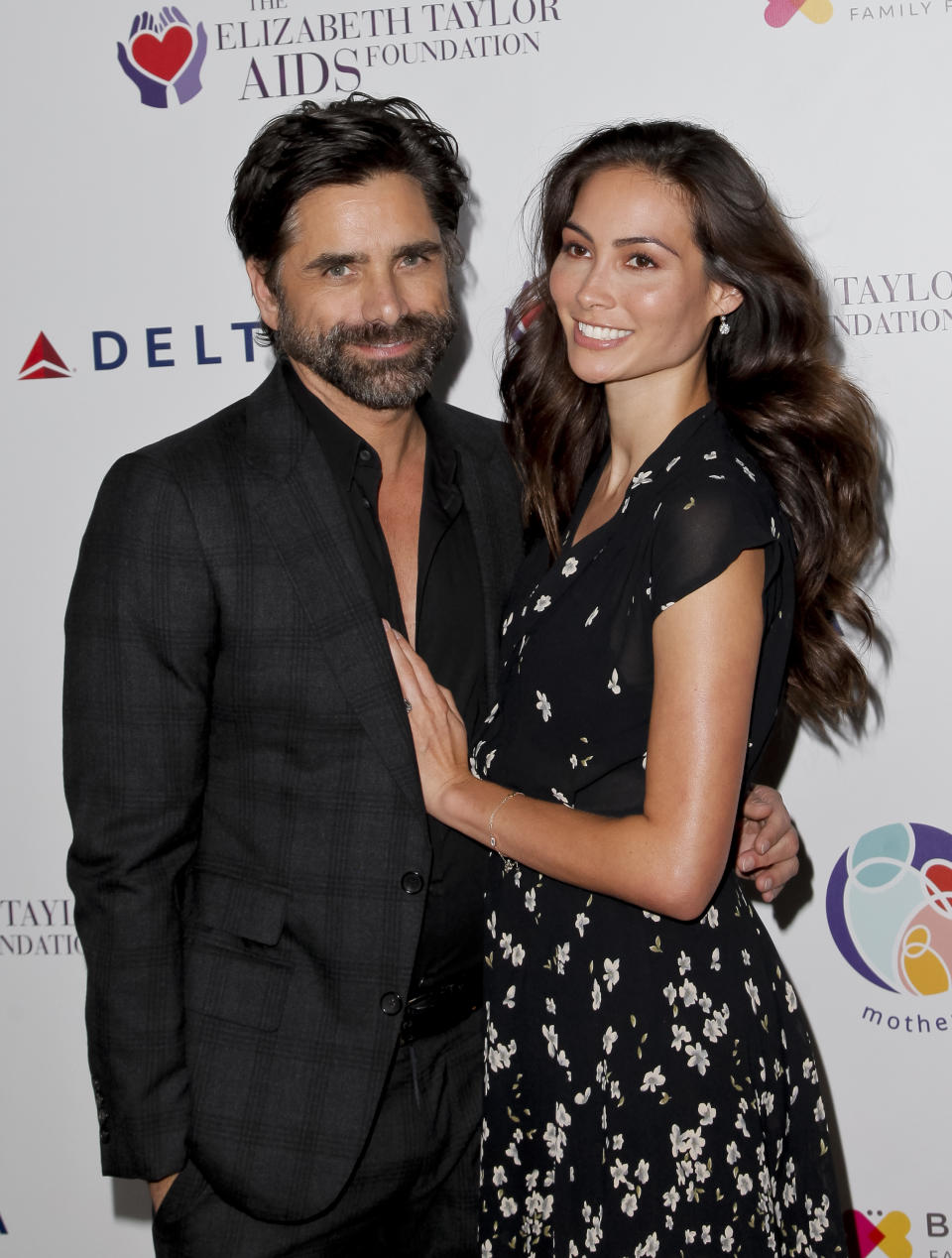 John Stamos and fiancée Caitlin McHugh. (Photo: Getty Images)