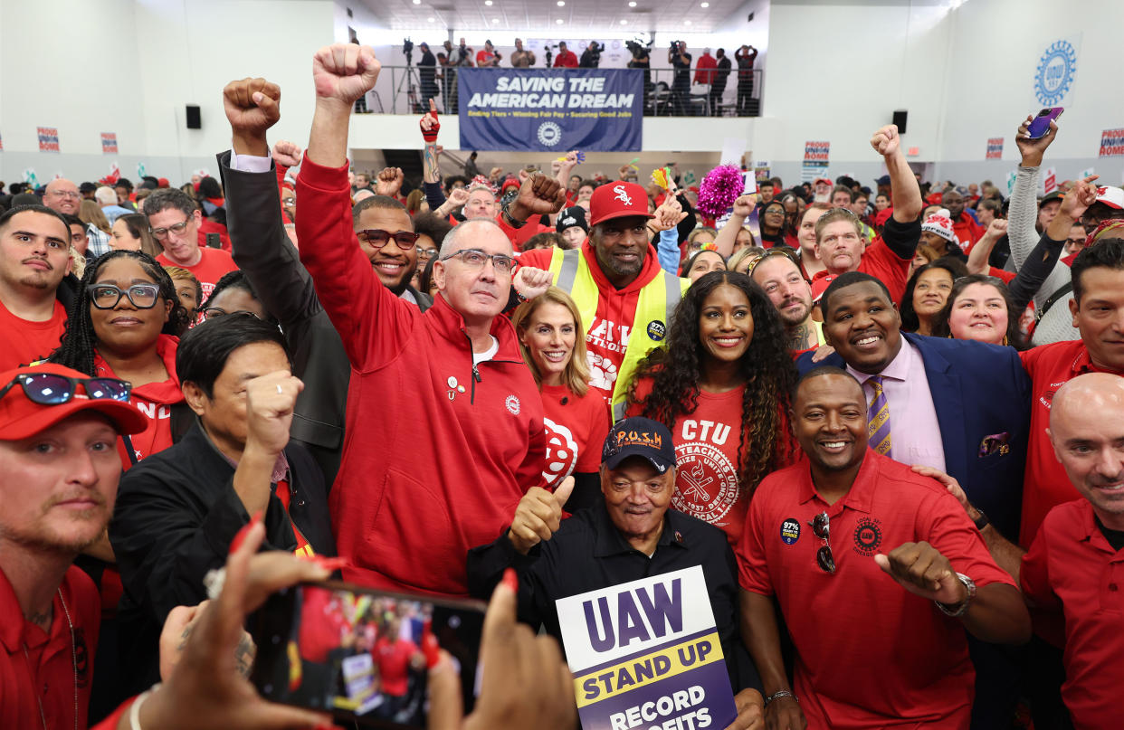 United Auto Workers President Shawn Fain, center left, stands for pictures with the Rev. Jesse Jackson, bottom center, after a rally for striking workers at UAW Local 551, 13550 S. Torrence Ave., Saturday, Oct. 7, 2023, in Chicago.
