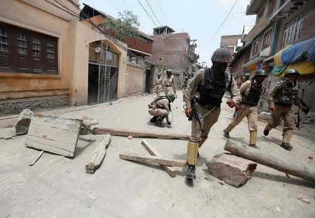 Policemen chase away protesters during a protest against the killing of Burhan Wani, a separatist militant leader, in Srinagar, July 10, 2016. REUTERS/Danish Ismail