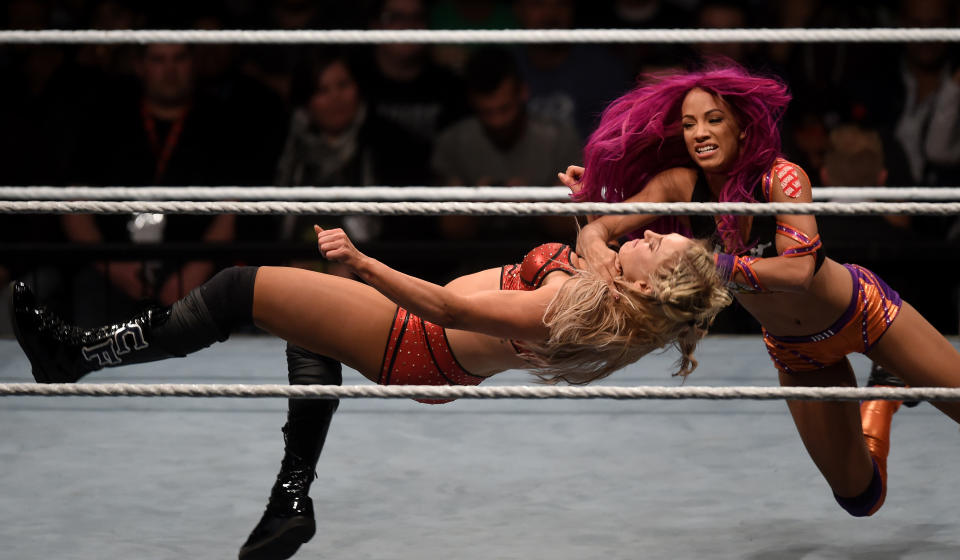 WWE wrestling stars Sasha Bank (R) and Charlotte Flair (L) fight during a WWE (World Wrestling Entertainment) women's fight at the Olympic hall in Munich, southern Germany, on November 3, 2016.  / AFP / CHRISTOF STACHE        (Photo credit should read CHRISTOF STACHE/AFP via Getty Images)