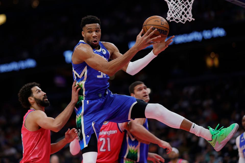 Bucks forward Giannis Antetokounmpo rebounds the ball over the  Wizards' Anthony Gill in the first quarter.