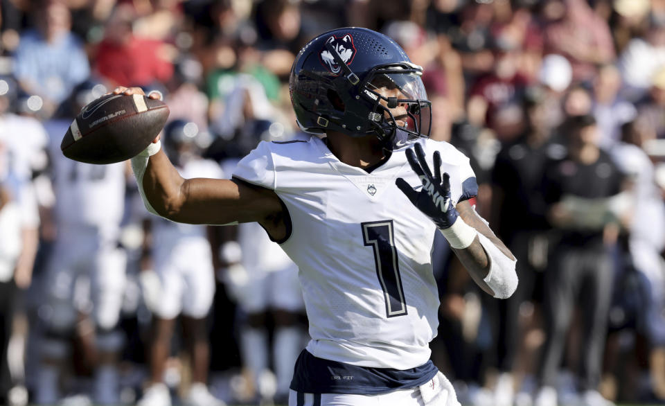 UConn quarterback Ta'Quan Roberson (1) throws during the second half of an NCAA college football game against Boston College Saturday, Oct. 28, 2023 in Boston. (AP Photo/Mark Stockwell)