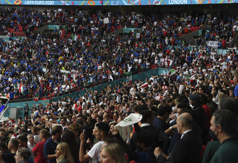 Fans cheer prior to the Euro 2020 final soccer match between Italy and England at Wembley stadium in London, Sunday, July 11, 2021. (Facundo Arrizabalaga/Pool via AP)