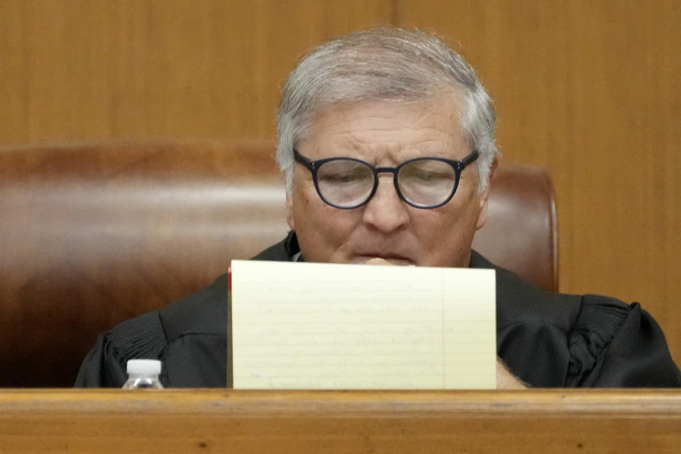 Hinds County Chancery Judge Dewayne Thomas studies his notes at a hearing, Wednesday, May 10, 2023, in Hinds County Chancery Court in Jackson, Miss., where he heard arguments about a Mississippi law that would create a court system with judges who would be appointed rather than elected. (AP Photo/Rogelio V. Solis)