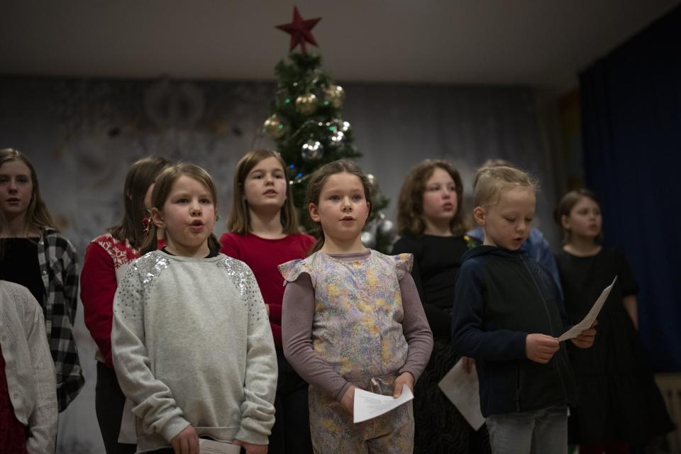 Members of the Polargospel, the children's choir at the only church in Svalbard, perform songs for Orthodox Christmas at the Barentsburg's school in Barentsburg, Norway, Saturday, Jan. 7, 2023. The choir traveled three hours each way by boat to mark Orthodox Christmas with the 40 children in Barentsburg, a village owned by Russia's Arctic mining company in the remote Norwegian territory. (AP Photo/Daniel Cole)