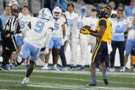 West Virginia's Traylon Ray catches a touchdown pass as North Carolina defensive back Armani Chatman looks on during the first half of an NCAA college football game at the Duke's Mayo Bowl Wednesday, Dec. 27, 2023, in Charlotte, N.C. (AP Photo/Chris Carlson)