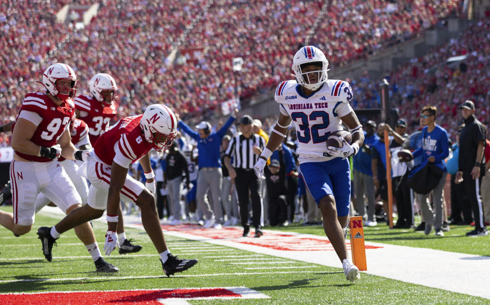 Louisiana Tech's Jacob Fields (32) runs in a touchdown ahead of Nebraska's DeShon Singleton (8) and Blaise Gunnerson (97) during the first half of an NCAA college football game, Saturday, Sept. 23, 2023, in Lincoln, Neb. (AP Photo/Rebecca S. Gratz)