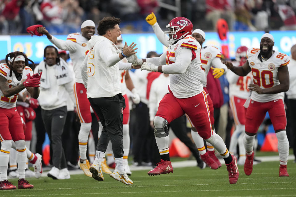 Kansas City Chiefs defensive tackle Chris Jones, center right, celebrates with teammate quarterback Patrick Mahomes, center in white hoodie, and others after sacking Los Angeles Chargers quarterback Easton Stick during the second half of an NFL football game, Sunday, Jan. 7, 2024, in Inglewood, Calif. The sack earned Jones a $1.25 million contract incentive. (AP Photo/Ashley Landis)