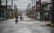 <p>TOPSHOT – Locals wade through a flooded street after the passage of Hurricane Irma, at Caibarien, Villa Clara province, 330km east of Havana, on Sept. 9, 2017. (Photo: Adalberto Roque/AFP/Getty Images) </p>