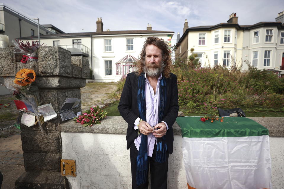 Liam O Maonlai, lead singer of the Hot House Flowers, stands outside the former home of Sinead O'Connor ahead of the late singer's funeral, in Bray, Co Wicklow, Ireland, Tuesday, Aug. 8, 2023. O’Connor’s family has invited the public to line the waterfront in Bray on Tuesday as her funeral procession passes by. Fans left handwritten notes outside her former home, thanking her for sharing her voice and her music. (Liam McBurneyPA via AP)