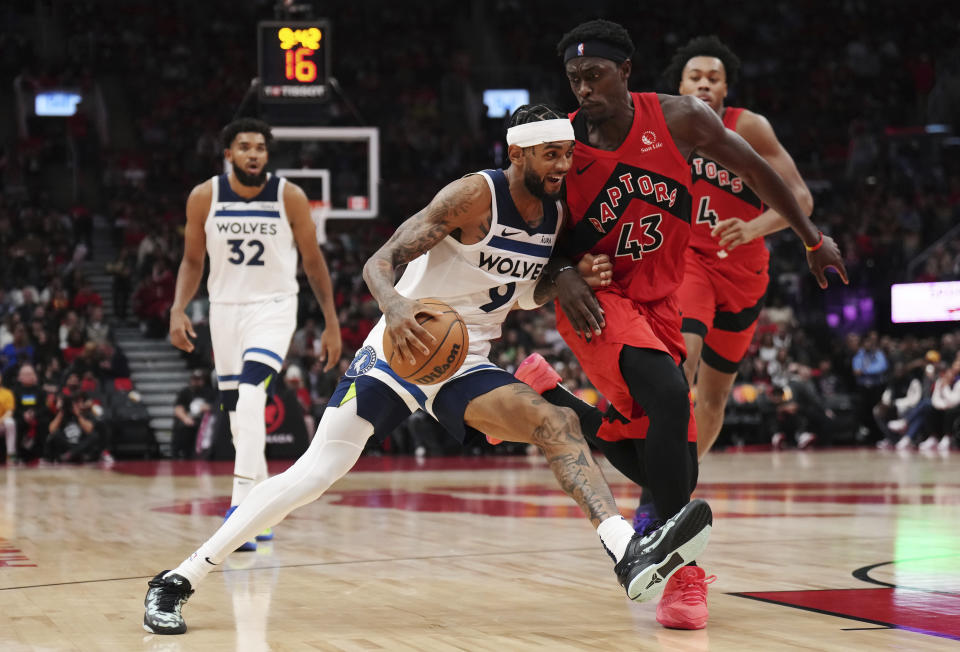 Minnesota Timberwolves' Nickeil Alexander-Walker (9) tries to drive past Toronto Raptors' Pascal Siakam (43) during the second half of an NBA basketball game Wednesday, Oct. 25, 2023, in Toronto. (Nathan Denette/The Canadian Press via AP)