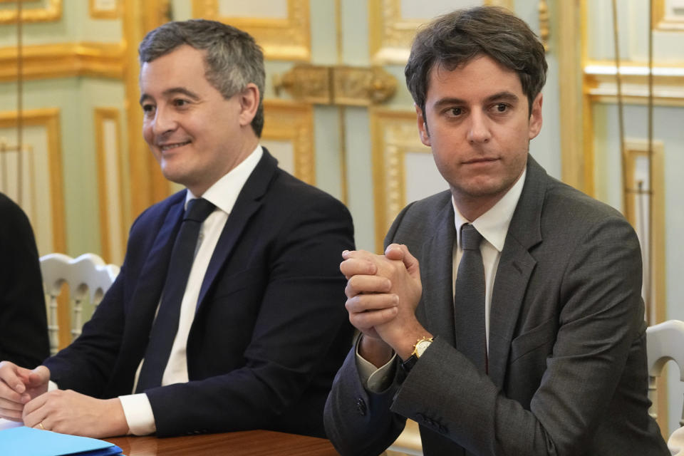 French Interior Minister Gérald Darmanin, left, and new French prime minister Gabriel Attal, attend the weekly cabinet meeting after a cabinet reshuffle, Friday, Jan. 12, 2024 at the Elysee Palace in Paris. (AP Photo/Michel Euler, Pool)