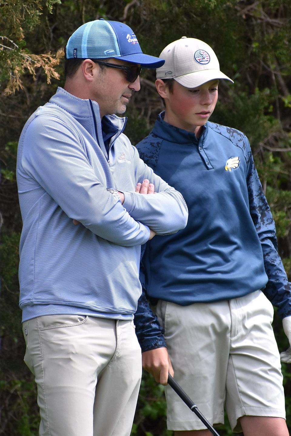 Hartland's Nathan Oake (left), working last season with Keller King, will be inducted into the Michigan Interscholastic Golf Coaches Association Hall of Fame in August.