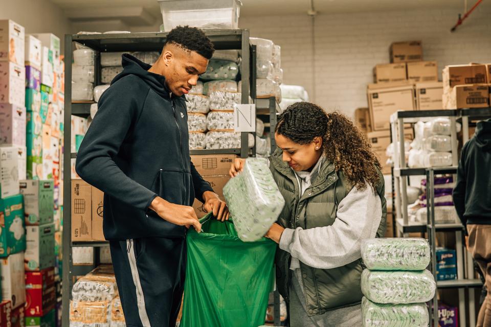 A photo of Giannis Antetokounmpo and Mariah Riddlesprigger at the Milwaukee Diaper Mission's former Bay View location in November of 2021.