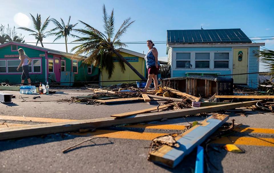Florida residents walk through hurrican damage