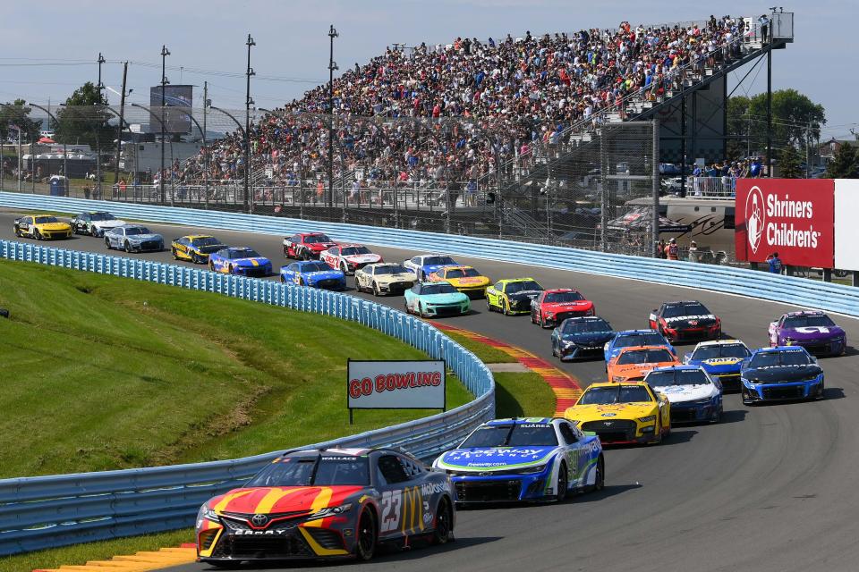 NASCAR Cup Series driver Bubba Wallace (23) leads a pack of drivers during the Go Bowling at The Glen at Watkins Glen International on Aug. 20, 2023.