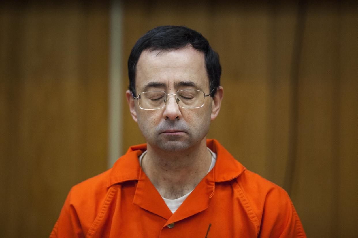 FILE – In this Feb. 5, 2018, file photo, Larry Nassar listens during his sentencing at Eaton County Circuit Court in Charlotte, Mich. Right in the midst of the Pyeongchang Games, with hardly enough time for Larry Nassar to settle into the prison cell where he’ll be spending the rest of his life, we got another report detailing horrific abuse and shameful cover-ups within one of the most high-profile summer sports. (Cory Morse/The Grand Rapids Press via AP, File)
