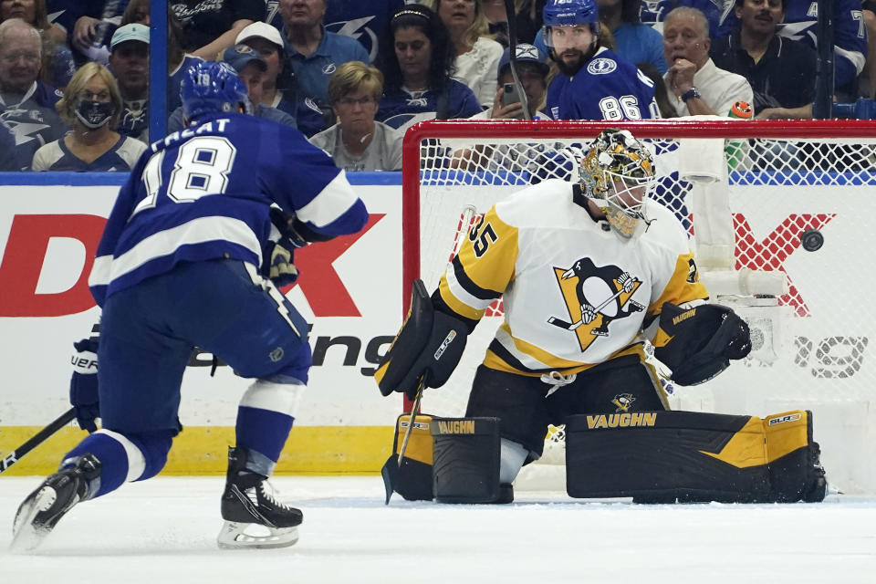 Pittsburgh Penguins goaltender Tristan Jarry (35) makes a save on a shot by Tampa Bay Lightning left wing Ondrej Palat (18) during the first period of an NHL hockey game Tuesday, Oct. 12, 2021, in Tampa, Fla. (AP Photo/Chris O'Meara)