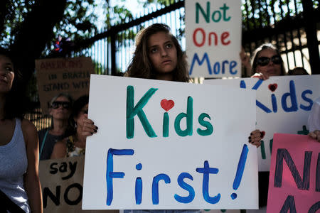 People take part in the "March for Our Lives", an organized demonstration to end gun violence in the United States, outside the U.S. Consulate in Sao Paulo, Brazil, March 24, 2018. REUTERS/Nacho Doce