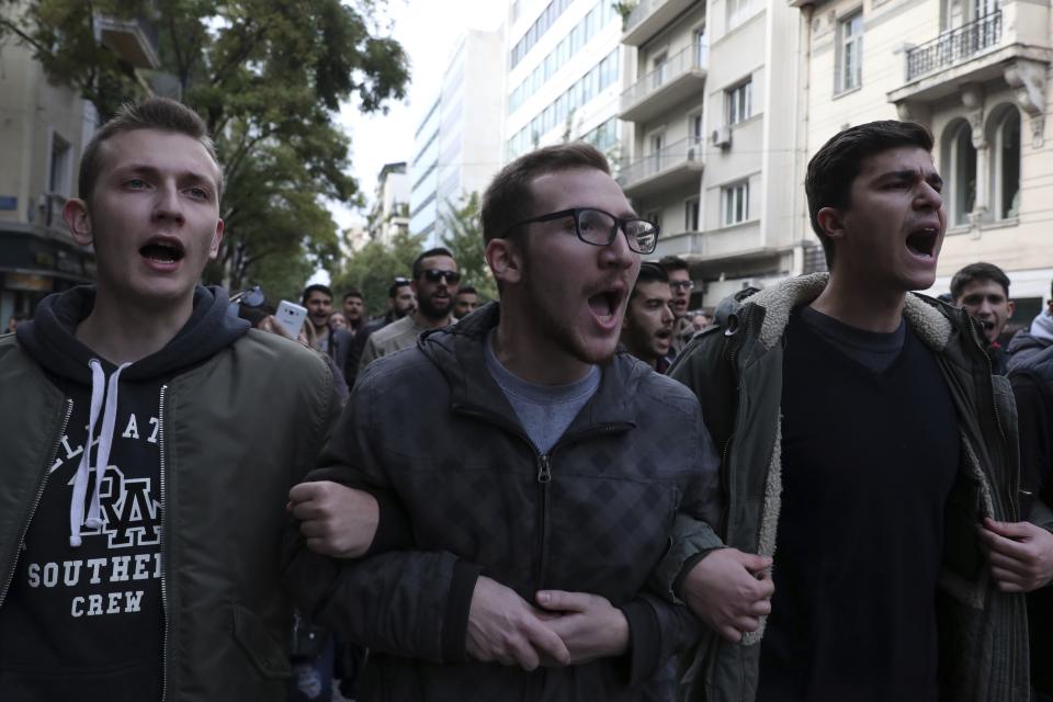 University students shout slogans during a rally in Athens, Saturday, Nov. 17, 2018. Several thousand people are expecting to march to the U.S. Embassy in Athens under tight police security to commemorate a 1973 student uprising that was crushed by Greece's military junta, that ruled the country from 1967-74. (AP Photo/Yorgos Karahalis)