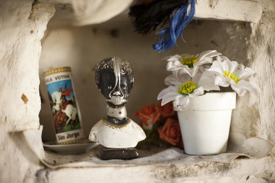 In this Sept. 15, 2012 photo, an image of slave Anastacia, a figure venerated by many as a saint in Brazil, decorates a public space in the Quilombo Sacopa in Rio de Janeiro, Brazil. Quilombos are communities founded by escaped slaves or their descendents, and in Sacopa, the community is trying to save the grouping of brick houses and shacks nestled in the lush foilage of Brazil’s coastal rainforest where families have made their home for more than century but never legally owned. (AP Photo/Victor R. Caivano)