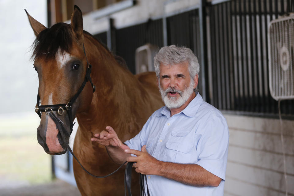 Dr. Robert Malone holds the reins of his stallion, Jade II Da Sernadinha, on his horse farm in Madison, Va., on Wednesday July 22, 2020. Malone, who serves as a consultant to a Pentagon-funded program that develops medications to protect American troops from biological threats, believed enough in famotidine’s efficacy and safety as a COVID-19 drug that, when he contracted the disease, he took it himself. He reported on his LinkedIn page that he’d figured out the proper dose and became “the first to take the drug to treat my own case." (AP Photo/Steve Helber)