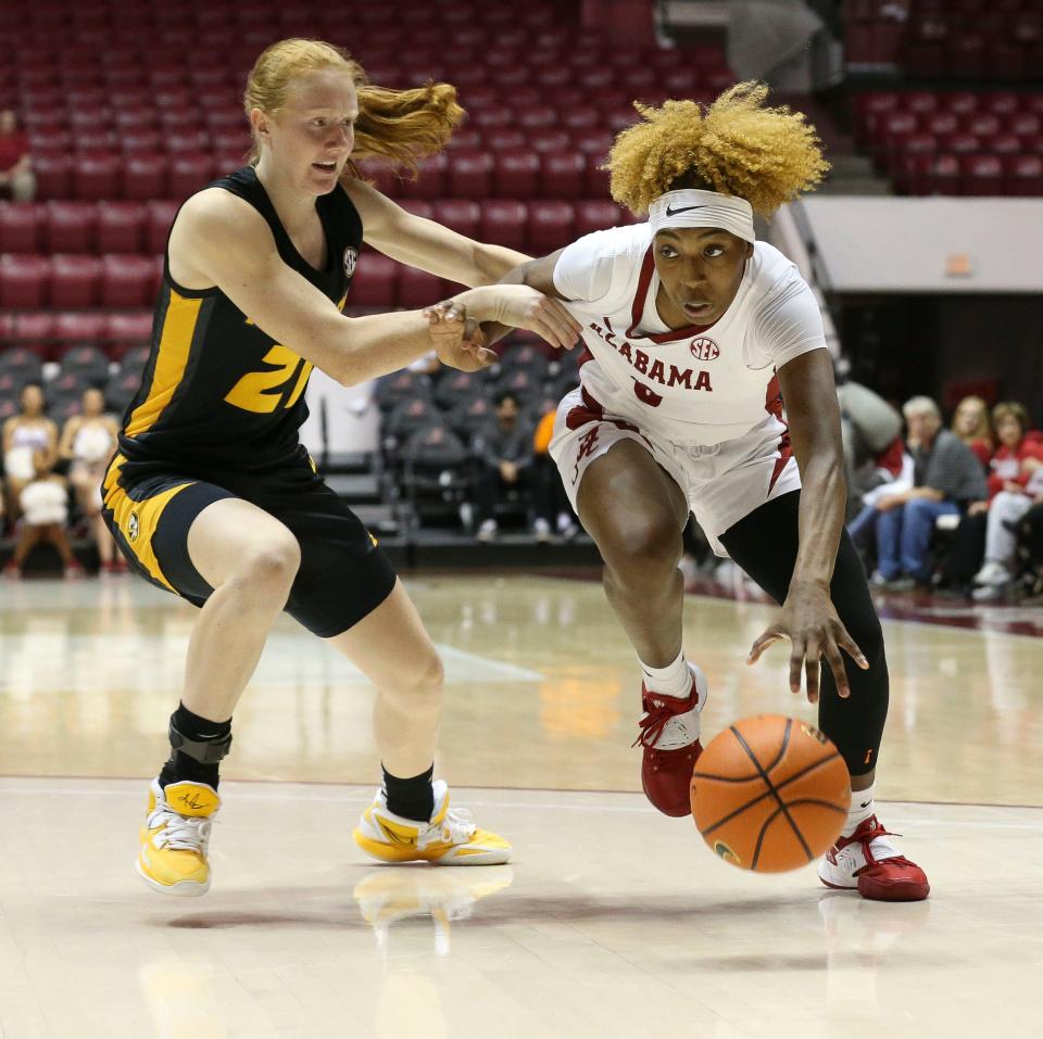 Jan 5, 2023; Tuscaloosa, AL, USA; Missouri guard Averi Kroenke (21) guards Alabama guard Loyal McQueen (0) as she drives the ball at Coleman Coliseum. 