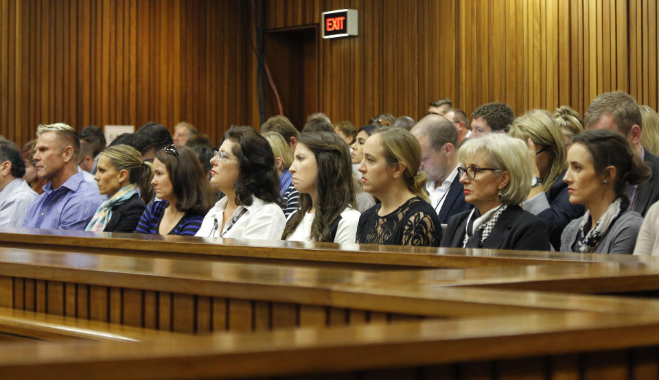 Members of the public and press, including sister of Oscar Pistorius Aimee Pistorius, fourth right, and aunt Lois Pistroius, second right, attend his murder trial as chief prosecutor Gerrie Nel questions Oscar Pistorius in court in Pretoria, South Africa, Monday, April 14, 2014. Pistorius who is charged with the murder of his girlfriend Reeva Steenkamp on Valentine's Day in 2013, is being cross-examined at his trial for the fourth day by Nel. (AP Photo/Kim Ludbrook, Pool)