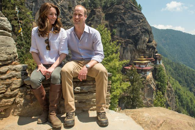 <p>Samir Hussein/Pool/WireImage</p> Kate Middleton and Prince William pose for a photo during their hike to Paro Taktsang, the Tiger's Nest monastery, in Bhutan on April 15, 2016