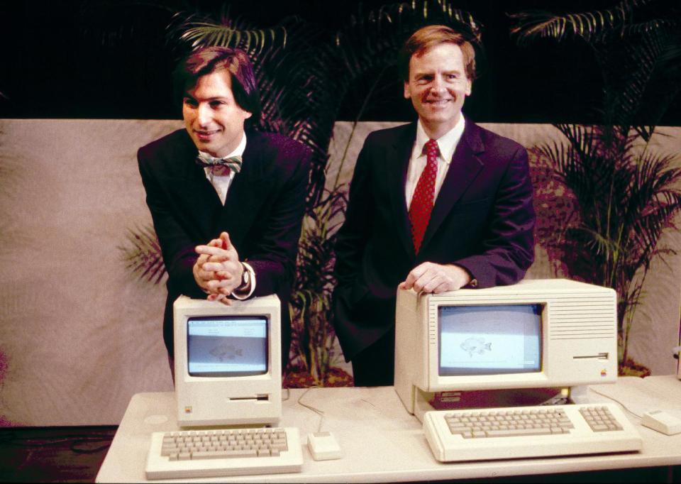 FILE -This January 1984, file photo, shows Steven P. Jobs, left and John Sculley presenting the new Macintosh Desktop Computer in January 1984 at a shareholder meeting in Cupertino, Calif. January 24, 2014, marks thirty years after the first Mac computer was introduced, sparking a revolution in computing and in publishing as people began creating fancy newsletters, brochures and other publications from their desktops. (AP Photo/FILE)