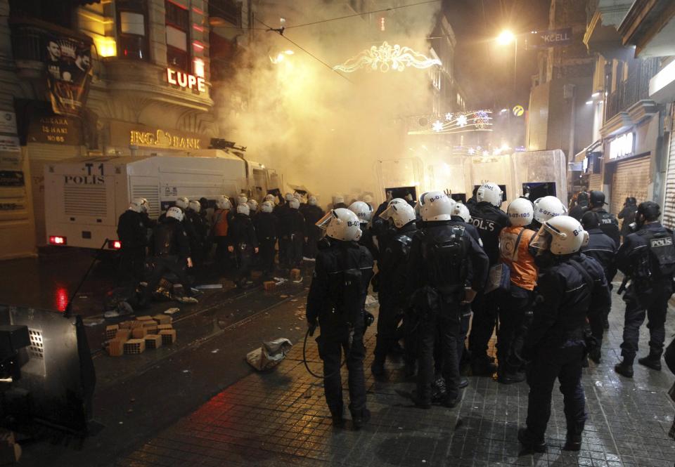 Riot police take position as they clash with demonstrators during a protest against internet censorship