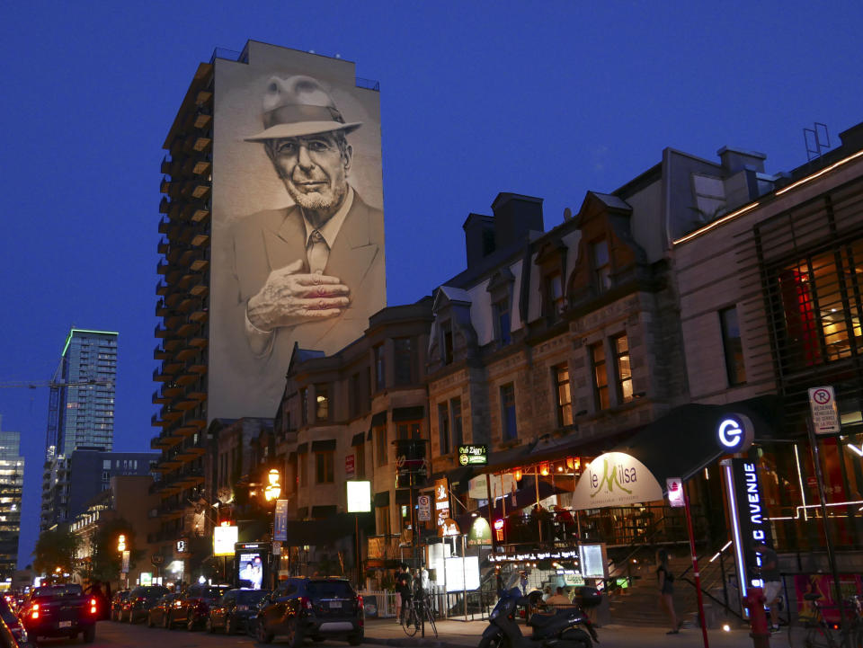 The mural of the late Canadian singer-songwriter Leonard Cohen, inaugurated in November 2017 over a Montreal street, now lit up every night, is viewed on June 23, 2019 on Crescent Street in Montreal. - The mural 