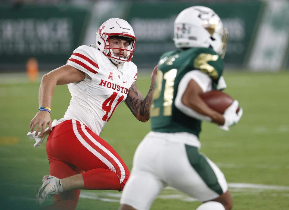 Houston place-kicker Bubba Baxa (41) chases South Florida's Brian Battie, who returns a kickoff for a touchdown during the first half of an NCAA college football game Saturday, Nov. 6, 2021, in Tampa, Fla. (AP Photo/Scott Audette)