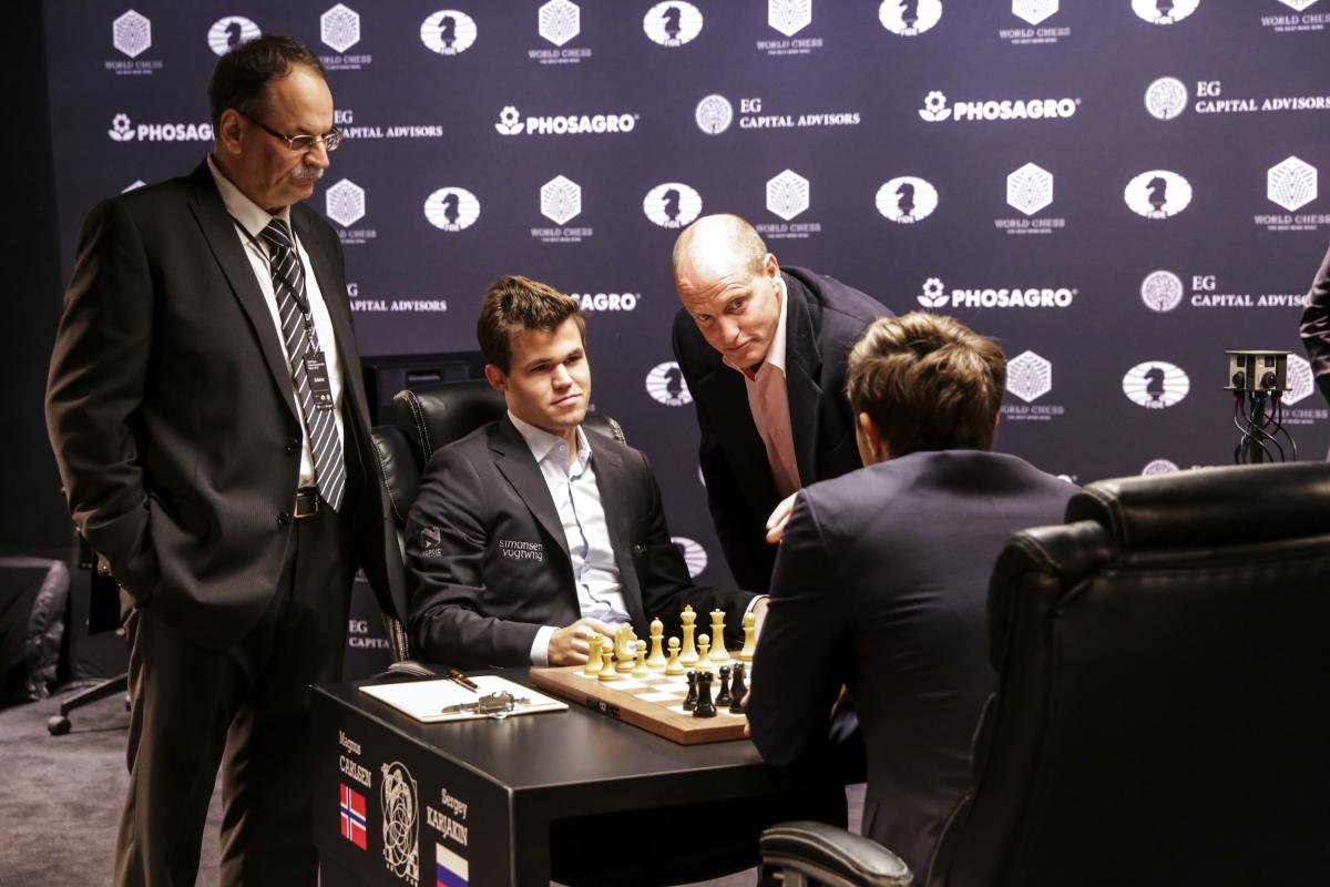 Reigning chess world champion Magnus Carlsen, right, from Norway, plays  Italian-American challenger Fabiano Caruana in the first five minutes of  round three of their World Chess Championship Match in London, Monday, Nov.