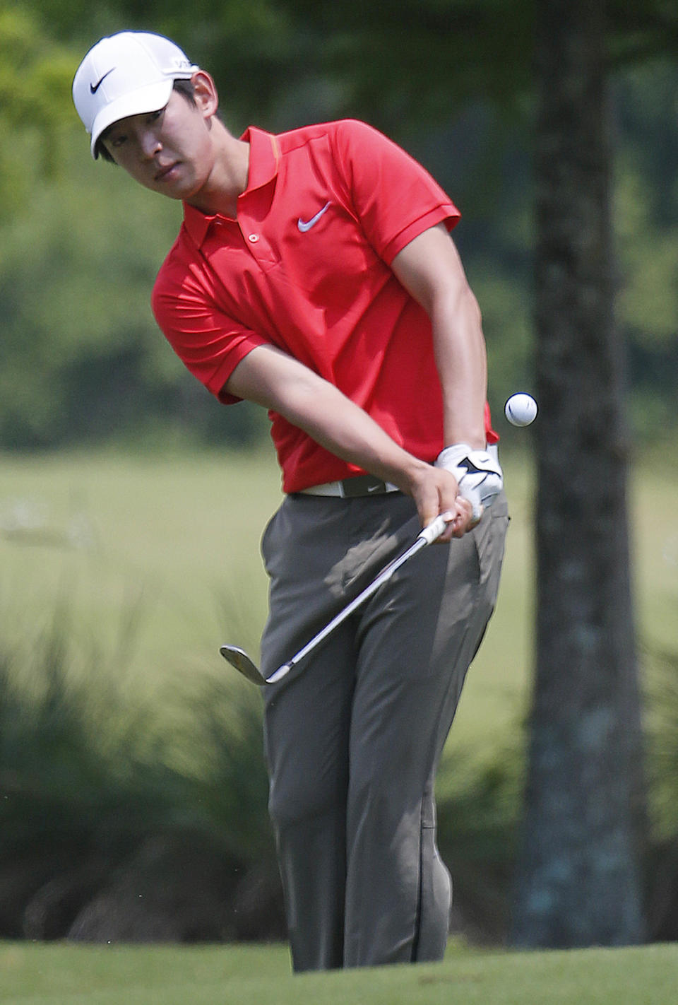 Noh Seung-Yul, of South Korea, chips onto the first green during the final round of the Zurich Classic golf tournament at TPC Louisiana in Avondale, La., Sunday, April 27, 2014. (AP Photo/Bill Haber)
