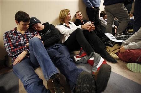 Tarah Camarillo (L-R), her partner Nicole Barnes, Leighton Hilburn and his partner Preston Perry wait in line with hundreds of other people to apply for a marriage license at the Salt Lake County Clerks office in Salt Lake City, Utah, December 23, 2013. REUTERS/Jim Urquhart