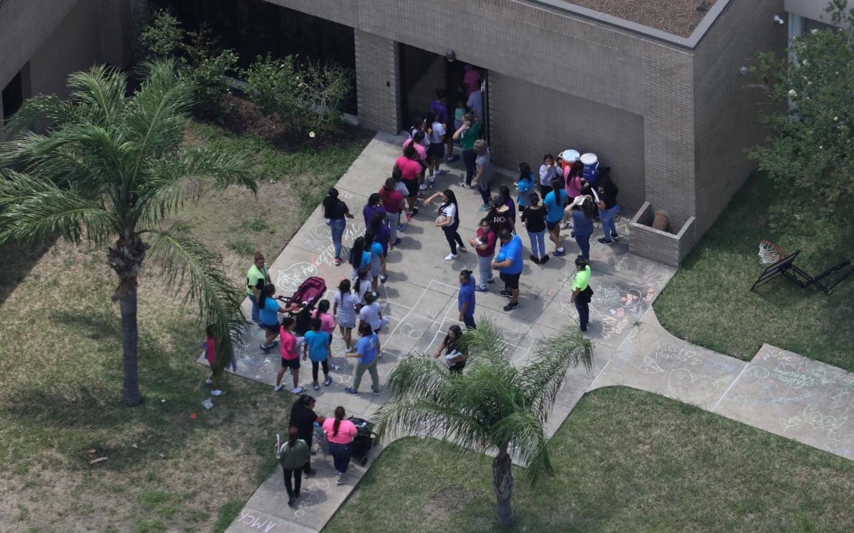 Migrant children make their way inside a building at Casa Presidente, an immigrant shelter for unaccompanied minors, in Brownsville - REUTERS