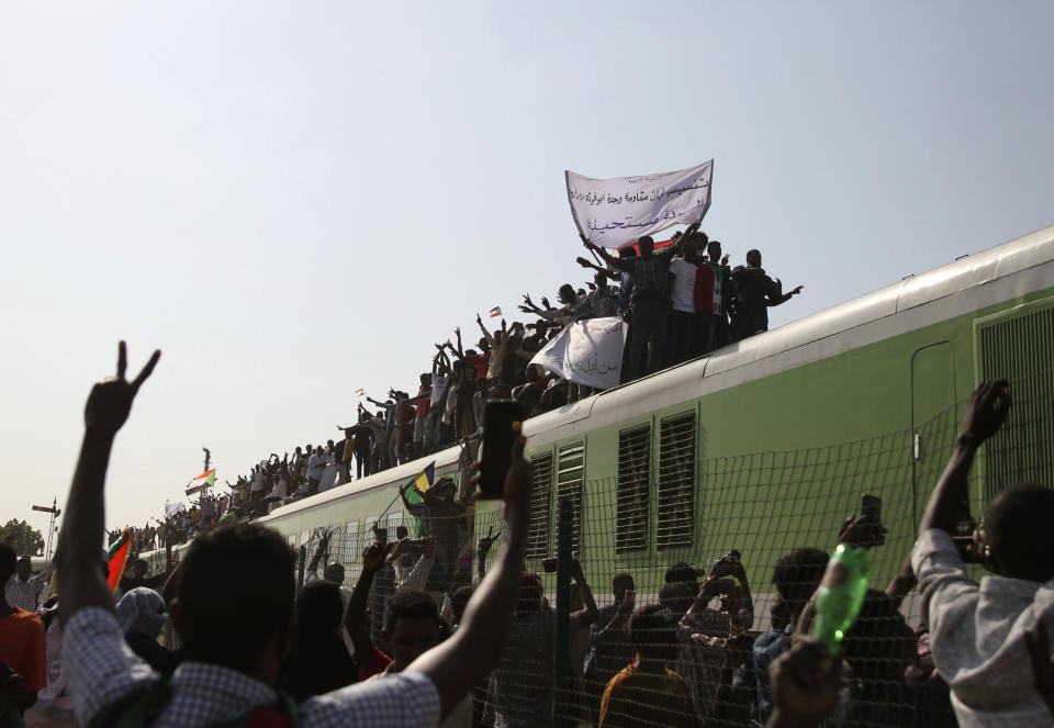 Sudanese demonstrators arrive by train to participate in a demonstration, in Khartoum, Sudan, Thursday, Sept. 30, 2021. Thousands of Sudanese have rallied in the capital of Khartoum against the country's military and demanding the formation of new transitional authorities that would exclusively consist of civilians. Thursday's demonstration accused the generals of derailing the country’s transition to democracy. (AP Photo/Marwan Ali)