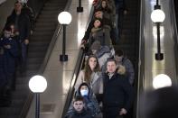 In this photo taken on Saturday, Feb. 22, 2020, people go down on the escalator in a Moscow's Metro (subway) station in Moscow, Russia. Metro workers were instructed to stop passengers from China and ask them to fill out a questionnaire about the purpose of their visit to Russia, address of residence, health condition and whether they underwent quarantine upon arrival. (AP Photo/Alexander Zemlianichenko)