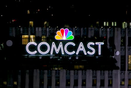 FILE PHOTO: The NBC and Comcast logo are displayed on top of 30 Rockefeller Plaza, formerly known as the GE building, in midtown Manhattan in New York