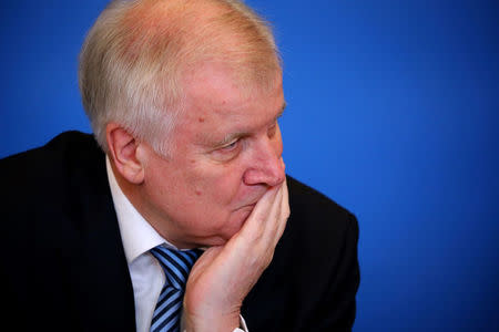 FILE PHOTO: German Interior Minister Horst Seehofer presents his "Migrant Masterplan" in Berlin, Germany, July 10, 2018. REUTERS/Hannibal Hanschke/File Photo