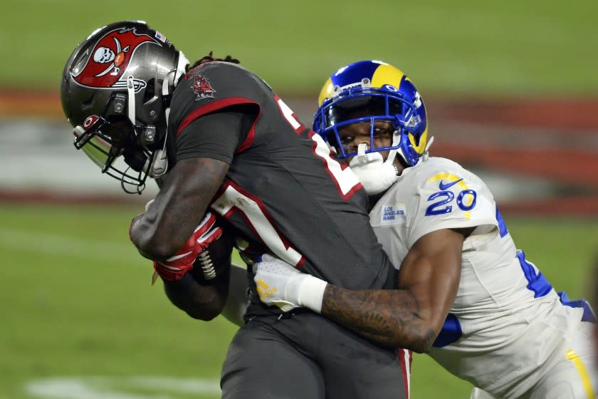 Los Angeles Rams cornerback Jalen Ramsey (20) stops Tampa Bay Buccaneers running back Ronald Jones (27) on a run during the first half of an NFL football game Monday, Nov. 23, 2020, in Tampa, Fla. (AP Photo/Jason Behnken)