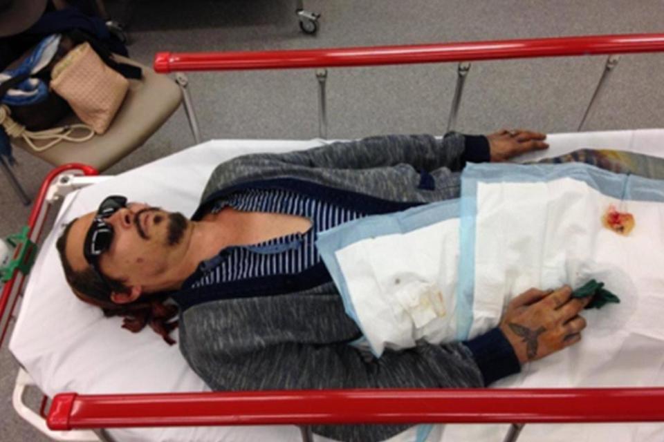 Mr Depp on a hospital bed after visiting hospital with an injured finger ()