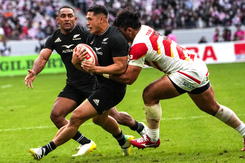 New Zealand's Roger Tuivasa-Sheck is tackled by Japan's Gu Jiwon, right, during the rugby international between the All Blacks and Japan at the National Stadium in Tokyo, Japan, Saturday, Oct. 29, 2022. (AP Photo/Shuji Kajiyama)