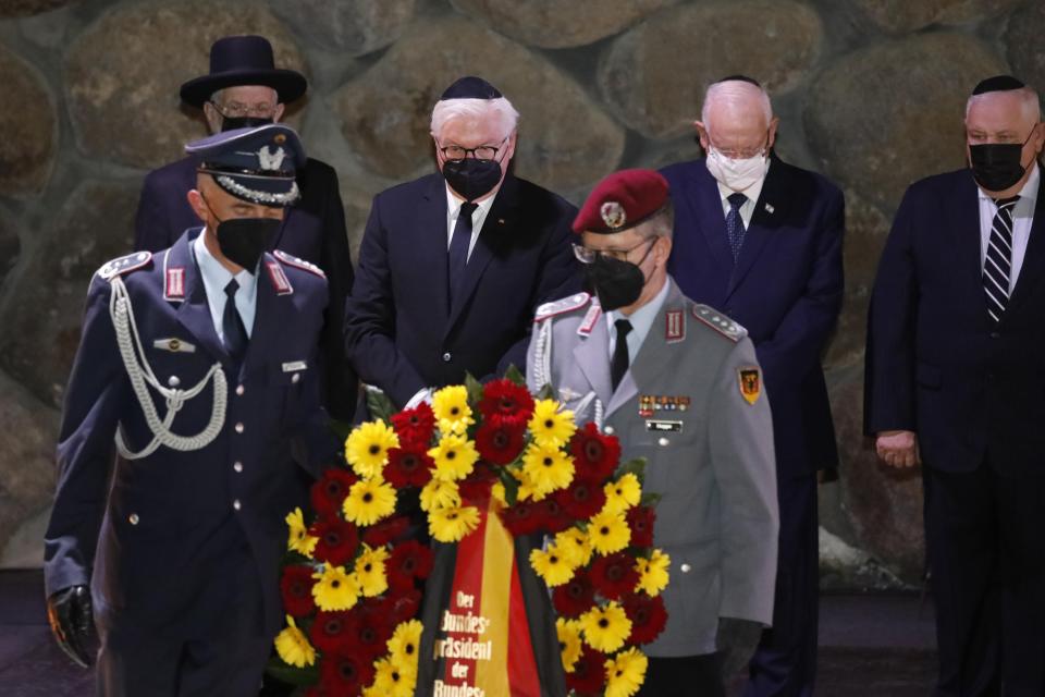 German President Frank-Walter Steinmeier, center, lays a wreath during a visit to the Hall of Remembrance at the Yad Vashem Holocaust memorial in Jerusalem, Thursday, July 1, 2021. (AP Photo/Ariel Schalit)