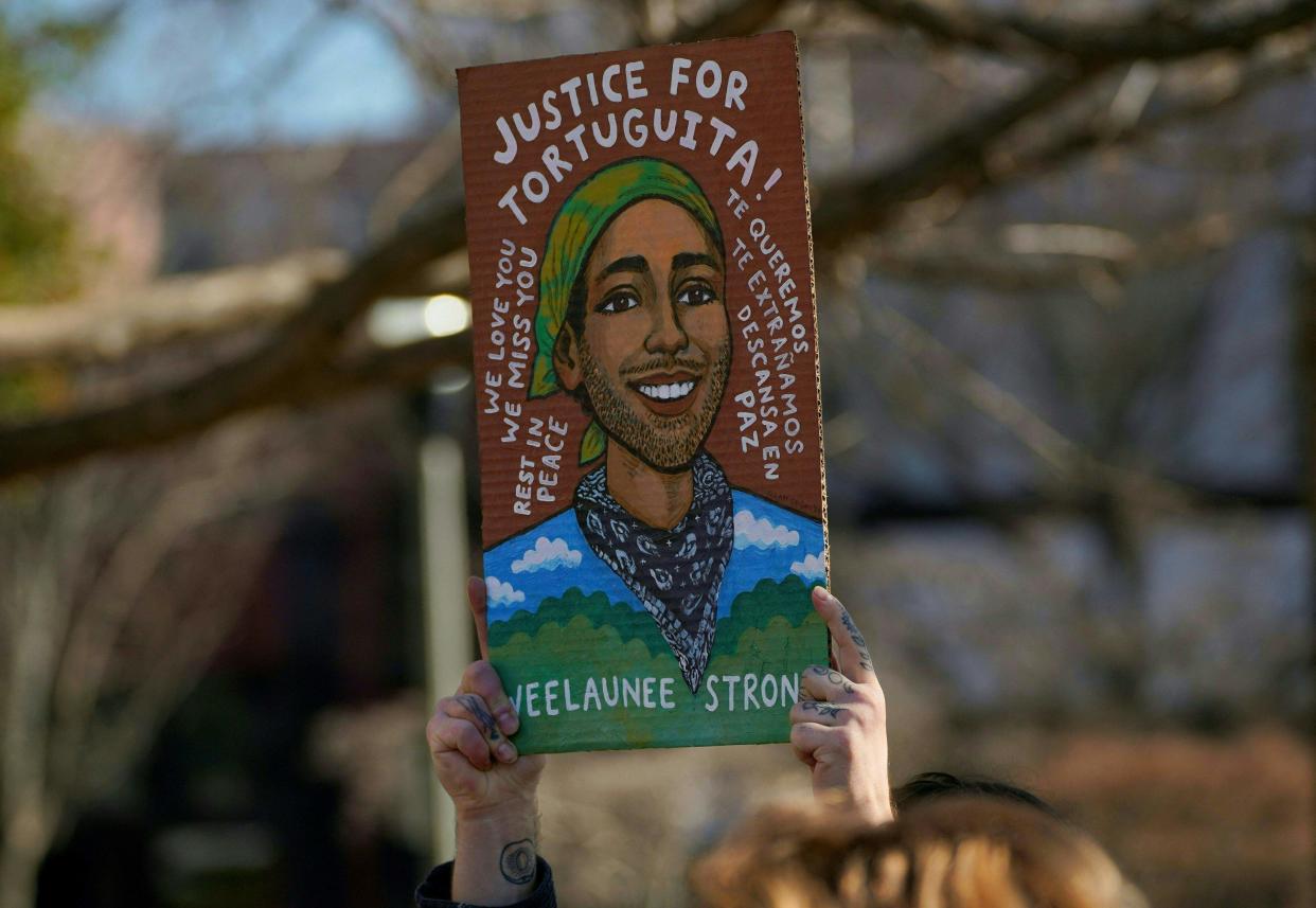 A mourner holds a painting of environmental activist Manuel Teran, who was killed by law enforcement during a raid to clear the construction site of a public safety training facility that activists have nicknamed "Cop City", during a press conference in Decatur, Georgia on February 6, 2023.