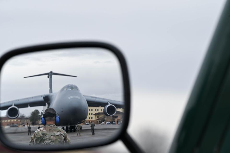 U.S. Air Force Master Sgt. Aaron Rogers, an air transportation ramp specialist with the 25th Aerial Port Squadron, observes C-5M Super Galaxy crew members from the 312th Airlift Squadron, 349th Air Mobility Wing, Travis Air Force Base, California, as they prepare for an engine running offload exercise, Jan. 8, 2023, at Maxwell Air Force Base, Alabama. An ERO maximizes efficiency with off-loading cargo from aircraft by not having to turn off the engines.