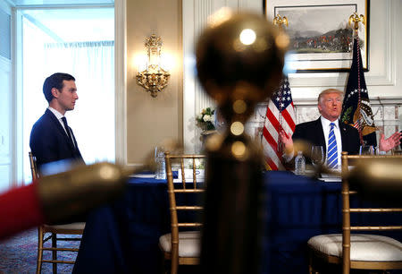 White House senior advisor Jared Kushner (L) listens as U.S. President Donald Trump speaks to reporters before meeting with participants in a workforce apprenticeship discussion at his golf estate in Bedminster, New Jersey U.S. August 11, 2017. REUTERS/Jonathan Ernst/Files